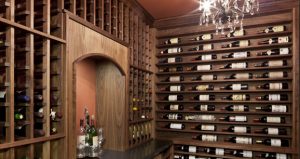 Wines lie on an their sides on a wine cellar wall