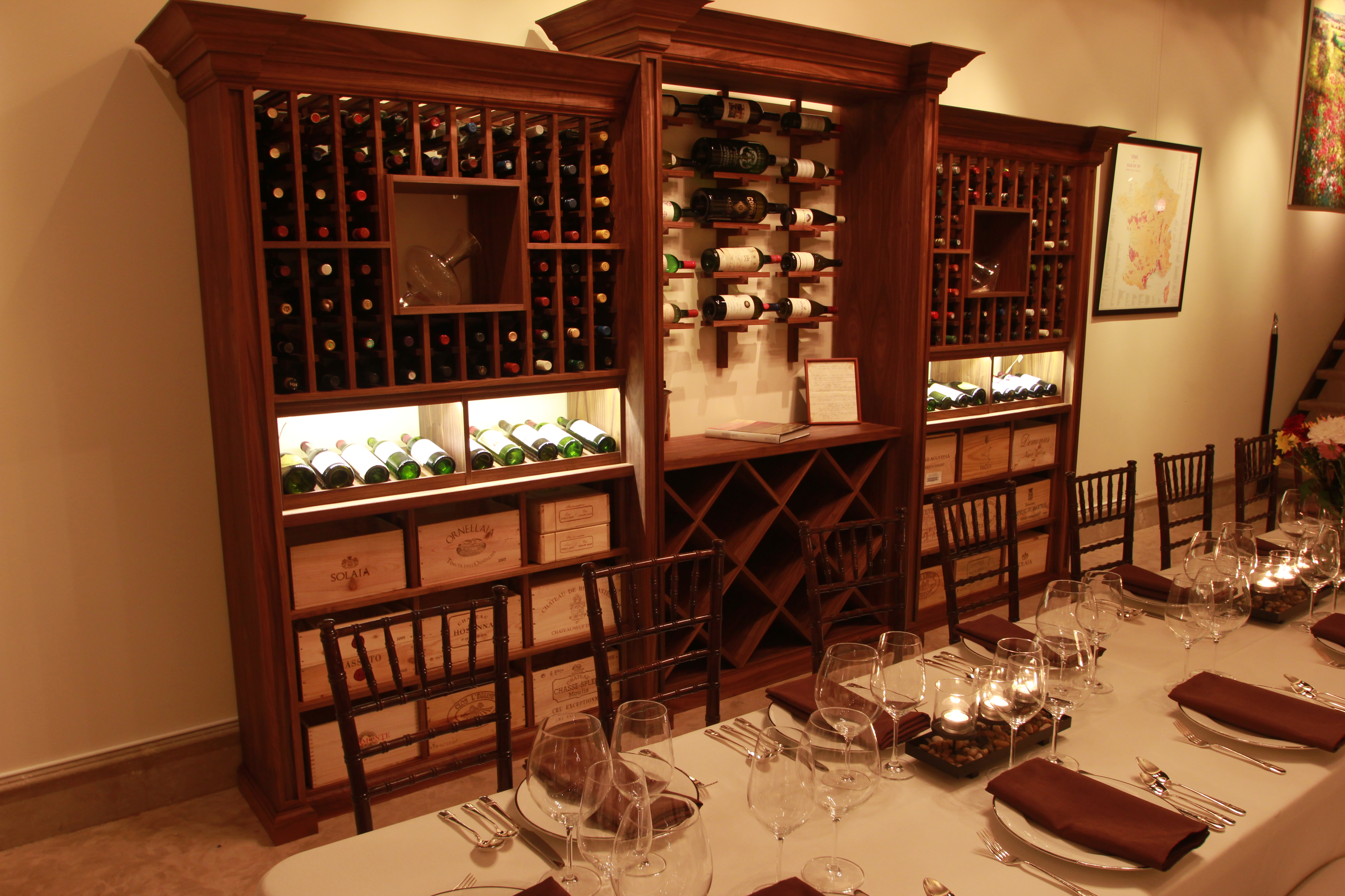 wine cabinet against the wall adds to Old World ambience for restaurant decor 
