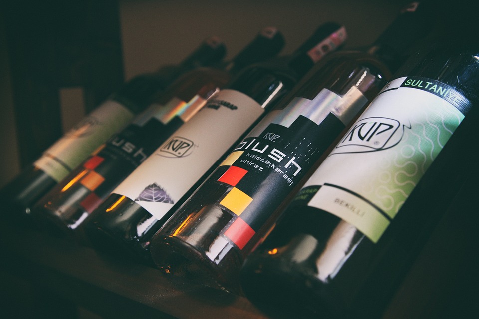 Several different wine bottles with different labels.