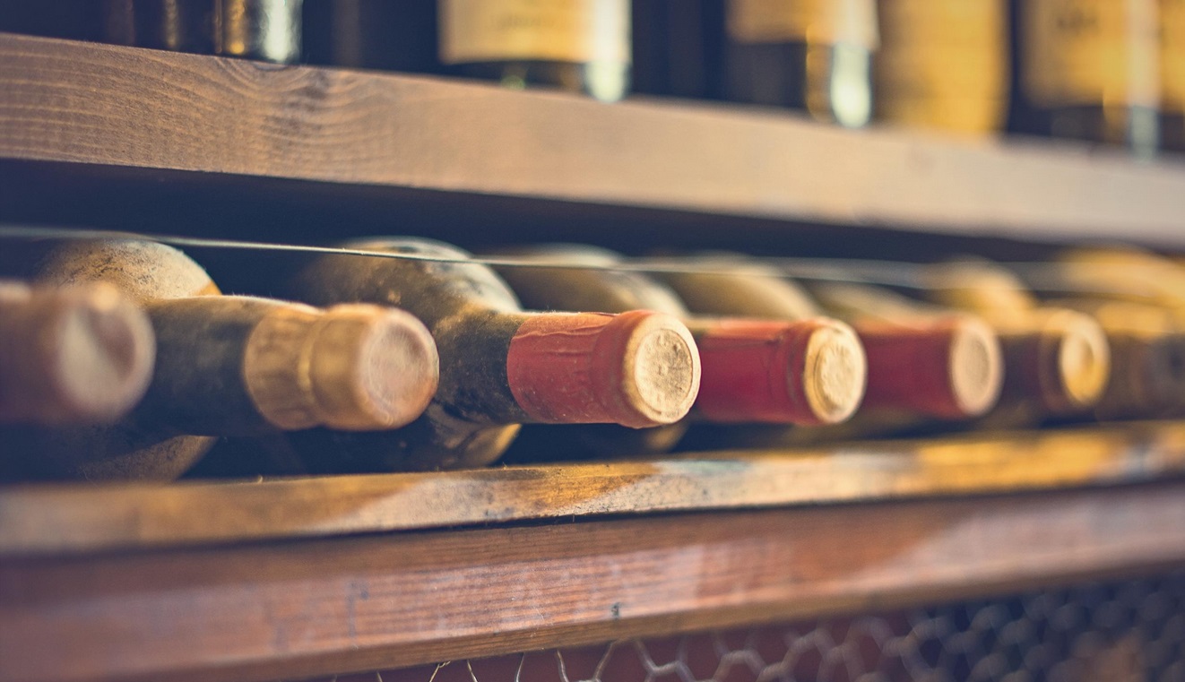 old wine bottles on wine rack