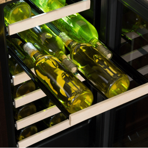 Wine bottles arranged on wine cooler shelves.